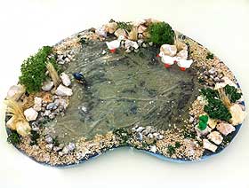 Photo showing a completed frozen miniature pond, with landscaped edging