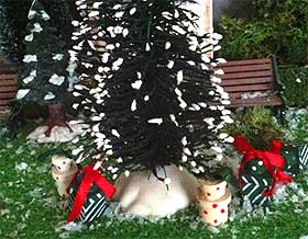 Photo of dolls house presents underneath a miniature Christmas tree