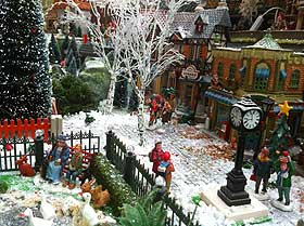 Photo of cobblestone street with scattered modelling snow and Lemax clock